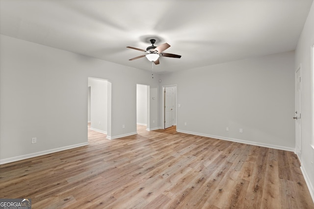 interior space featuring light wood-style floors, baseboards, and a ceiling fan