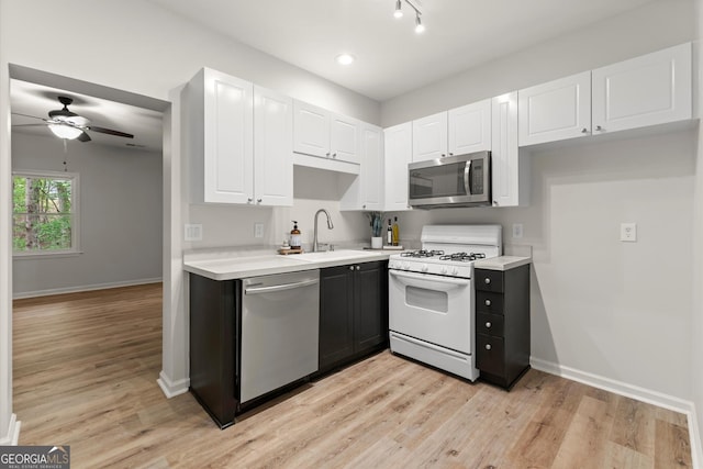 kitchen featuring a sink, light countertops, a ceiling fan, and appliances with stainless steel finishes
