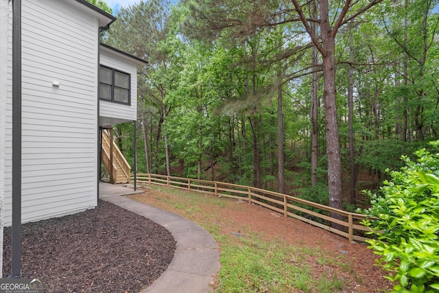 view of yard featuring stairs and a fenced backyard