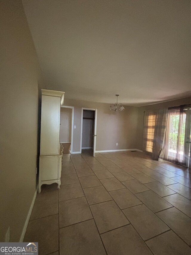 9163 Fair St SW, Covington, GA 30014 - tiled spare room with baseboards and a notable chandelier