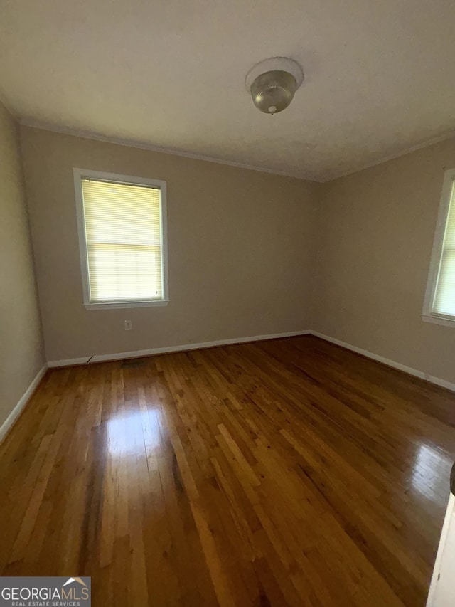 9163 Fair St SW, Covington, GA 30014 - spare room with crown molding, baseboards, and hardwood / wood-style floors