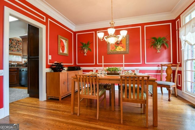 dining room with ornamental molding and a decorative wall
