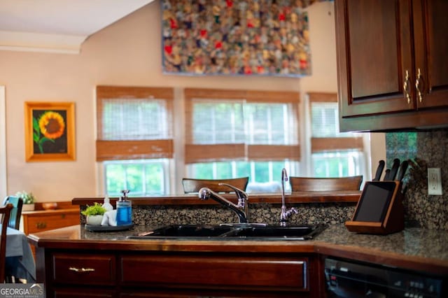 kitchen featuring backsplash, dark brown cabinetry, a sink, and dishwasher