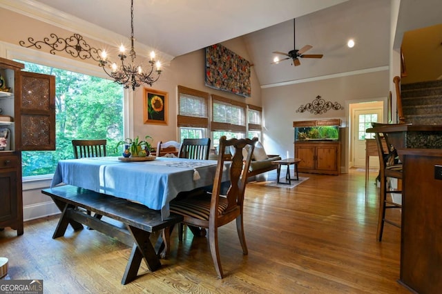 dining room with plenty of natural light, ornamental molding, and ceiling fan with notable chandelier