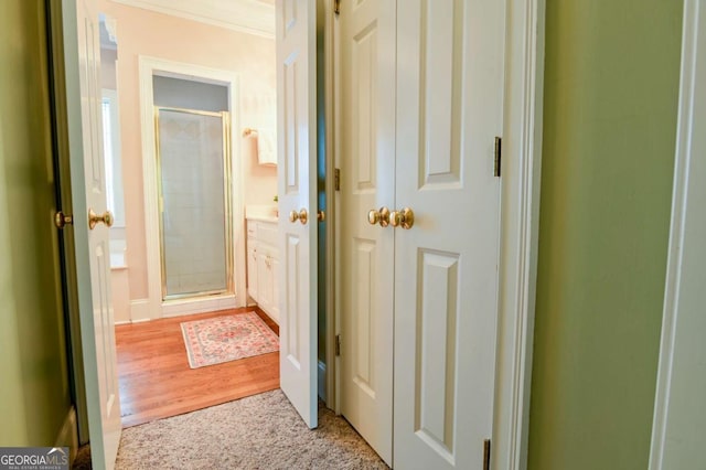 hall with baseboards and wood finished floors