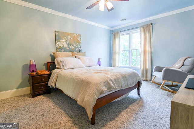carpeted bedroom with baseboards, visible vents, ornamental molding, and ceiling fan