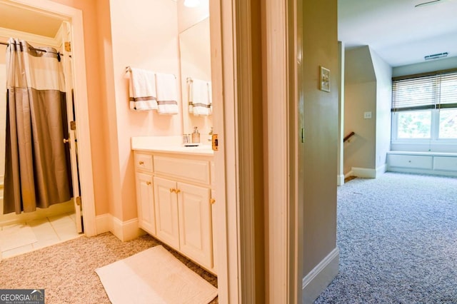 full bath with baseboards, vanity, and curtained shower