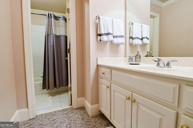 full bath featuring crown molding, vanity, and shower / tub combo with curtain
