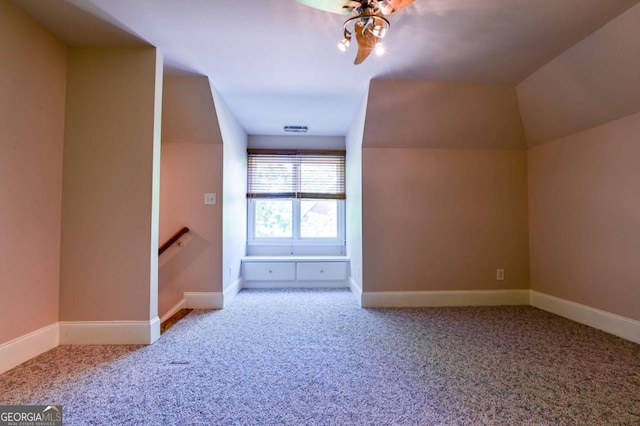 additional living space with carpet floors, baseboards, and visible vents