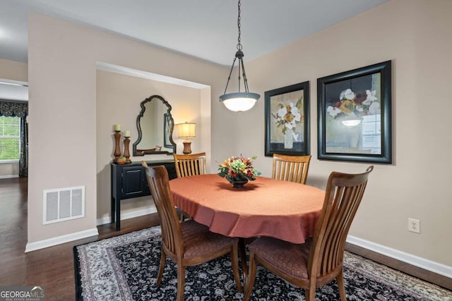 661 Village Field Ct NW, Suwanee, GA 30024 - dining room with visible vents, baseboards, and dark wood finished floors