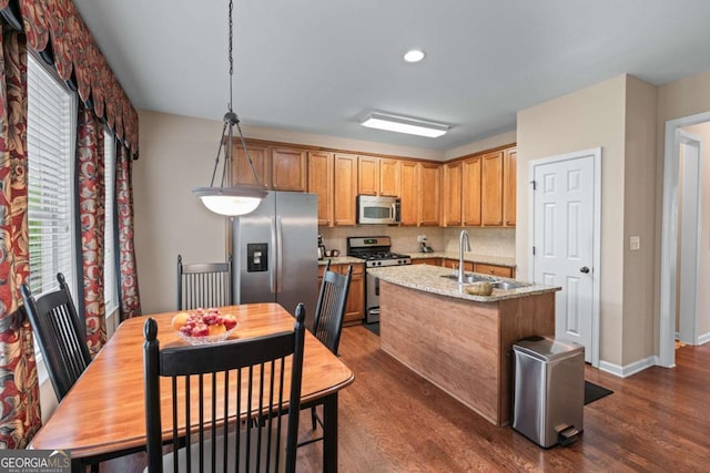 661 Village Field Ct NW, Suwanee, GA 30024 - kitchen with a sink, appliances with stainless steel finishes, dark wood-style floors, and a center island with sink