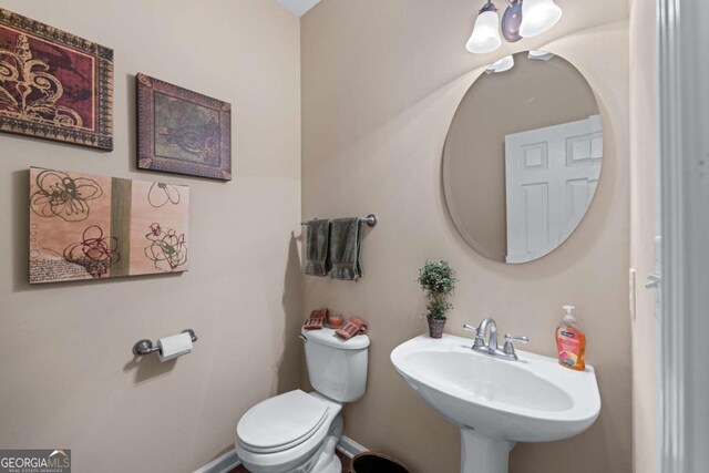 661 Village Field Ct NW, Suwanee, GA 30024 - half bathroom with a sink and toilet