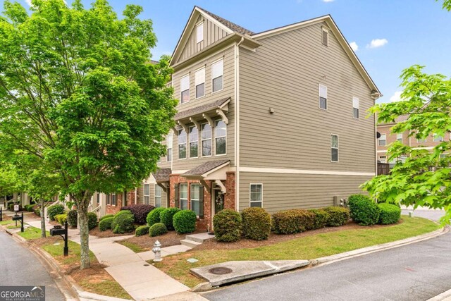 661 Village Field Ct NW, Suwanee, GA 30024 - view of property exterior featuring board and batten siding and brick siding