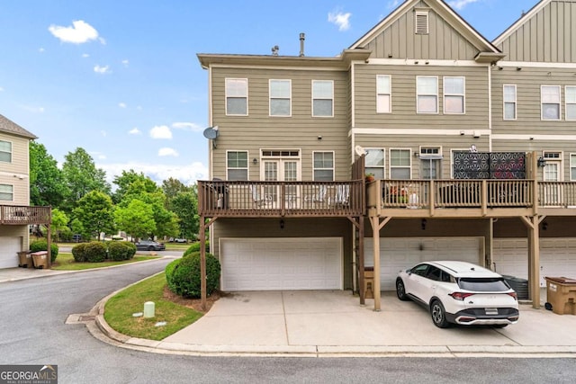 661 Village Field Ct NW, Suwanee, GA 30024 - view of front facade with a garage, board and batten siding, and driveway