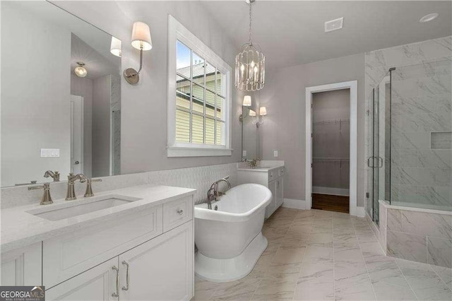 7235 Cordery Rd, Cumming, GA 30040 - bathroom featuring a notable chandelier, a freestanding bath, marble finish floor, and a stall shower