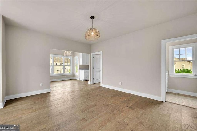 7235 Cordery Rd, Cumming, GA 30040 - spare room featuring a healthy amount of sunlight, baseboards, and wood finished floors