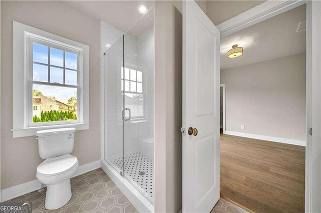 7235 Cordery Rd, Cumming, GA 30040 - bathroom featuring baseboards, a shower stall, toilet, and visible vents