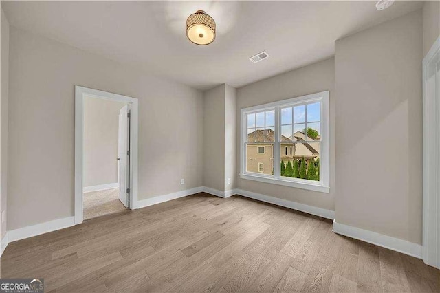 7235 Cordery Rd, Cumming, GA 30040 - empty room with visible vents, baseboards, and wood finished floors