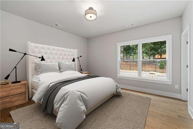 7235 Cordery Rd, Cumming, GA 30040 - bedroom featuring baseboards, light wood-type flooring, and visible vents