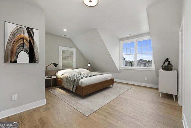 7235 Cordery Rd, Cumming, GA 30040 - bedroom featuring baseboards, light wood-style floors, visible vents, and vaulted ceiling