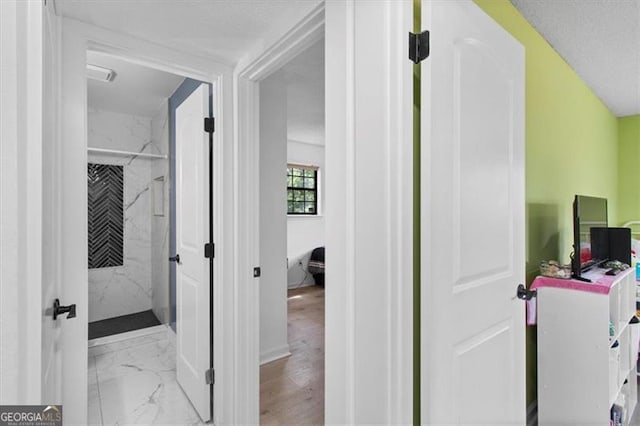 interior space with baseboards and marble finish floor