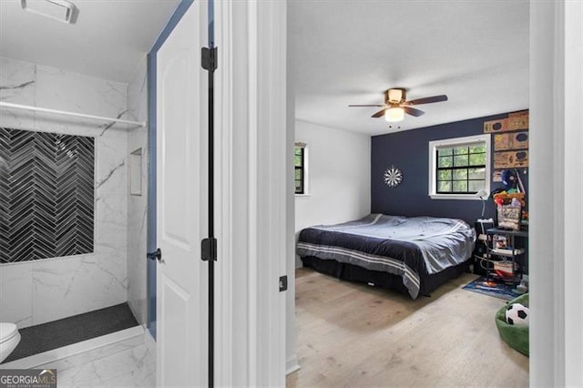bedroom with a ceiling fan and marble finish floor