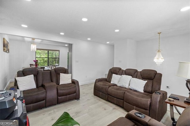 living area with recessed lighting, baseboards, and light wood-type flooring