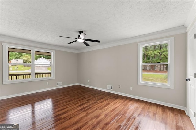 2979 Overwood Ln SW, Snellville, GA 30078 - unfurnished room with wood finished floors, plenty of natural light, a ceiling fan, ornamental molding, and a textured ceiling