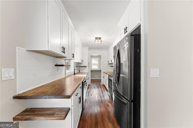 2979 Overwood Ln SW, Snellville, GA 30078 - kitchen with appliances with stainless steel finishes, white cabinetry, and dark wood-style floors