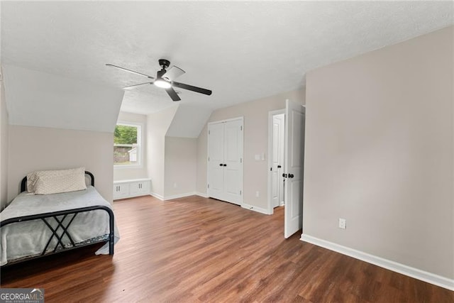 2979 Overwood Ln SW, Snellville, GA 30078 - unfurnished bedroom with wood finished floors, ceiling fan, and lofted ceiling