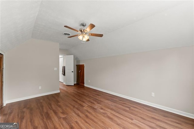 2979 Overwood Ln SW, Snellville, GA 30078 - additional living space with vaulted ceiling, a ceiling fan, and wood finished floors