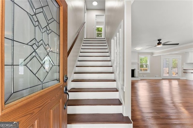 2979 Overwood Ln SW, Snellville, GA 30078 - stairway with wood finished floors, french doors, a ceiling fan, and ornamental molding