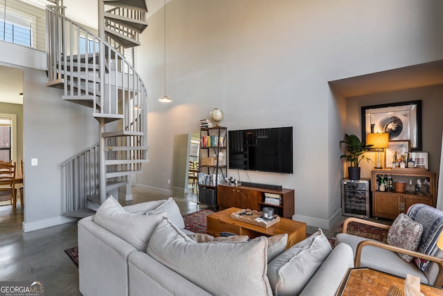 791 Wylie St SE Unit 912, Atlanta, GA 30316 - living area featuring baseboards, a high ceiling, stairs, and beverage cooler