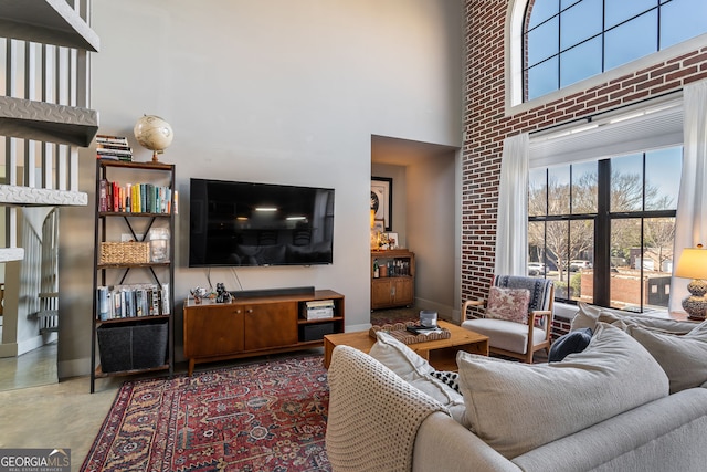 791 Wylie St SE Unit 912, Atlanta, GA 30316 - living room featuring baseboards, concrete floors, and a towering ceiling