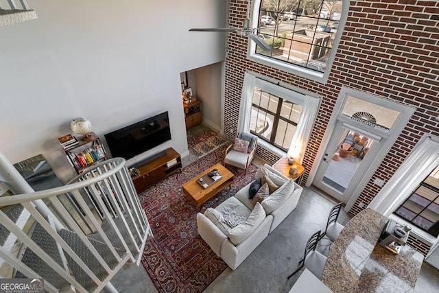 791 Wylie St SE Unit 912, Atlanta, GA 30316 - living room with a high ceiling, a fireplace, and brick wall