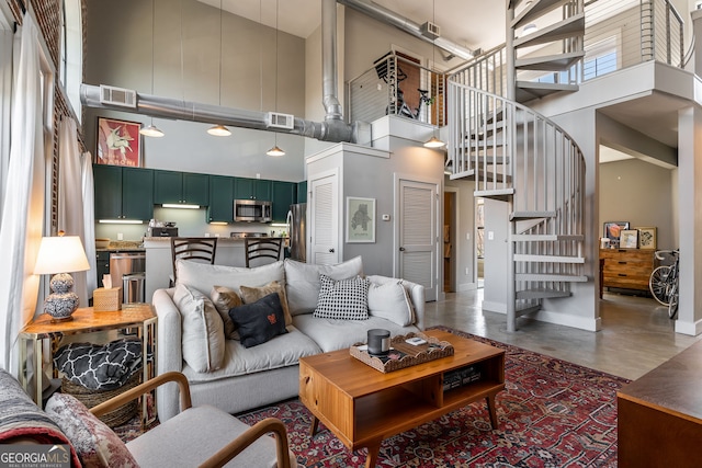 791 Wylie St SE Unit 912, Atlanta, GA 30316 - living area featuring visible vents, baseboards, concrete floors, a high ceiling, and stairs