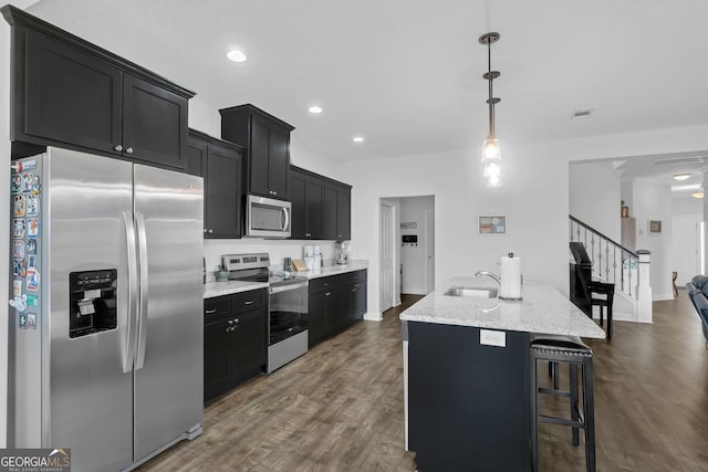 113 Hamlet Ct, Hinesville, GA 31313 - kitchen with dark cabinets, appliances with stainless steel finishes, dark wood-style flooring, and a sink