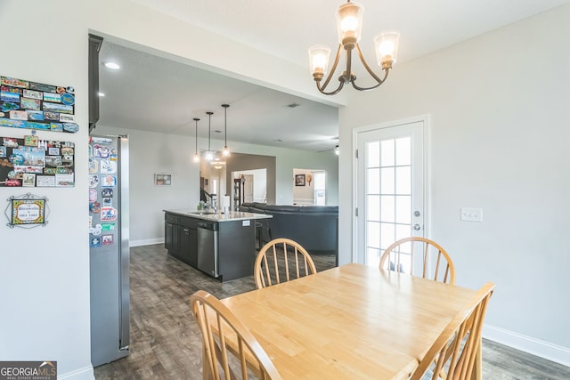 113 Hamlet Ct, Hinesville, GA 31313 - dining area featuring baseboards, an inviting chandelier, visible vents, and dark wood-type flooring