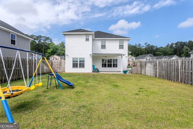 113 Hamlet Ct, Hinesville, GA 31313 - rear view of property featuring a playground, a lawn, a fenced backyard, and a patio area