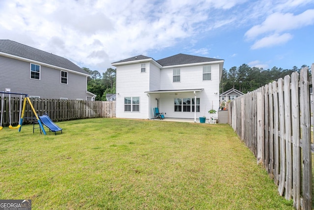 113 Hamlet Ct, Hinesville, GA 31313 - back of house featuring a lawn, a fenced backyard, and a playground