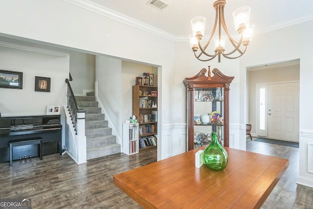 113 Hamlet Ct, Hinesville, GA 31313 - dining area featuring dark wood-style flooring, visible vents, an inviting chandelier, ornamental molding, and stairs