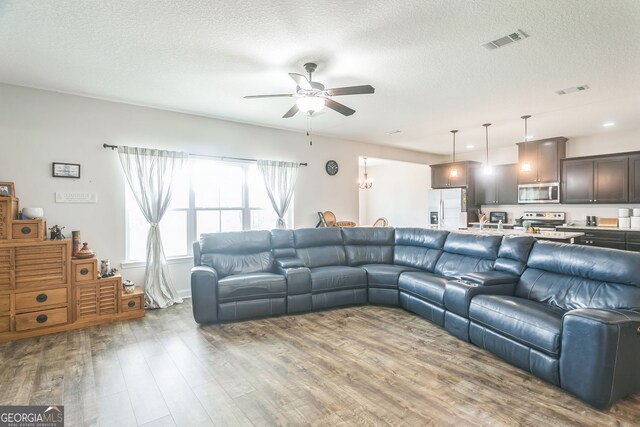 113 Hamlet Ct, Hinesville, GA 31313 - living room with a textured ceiling, a ceiling fan, wood finished floors, and visible vents