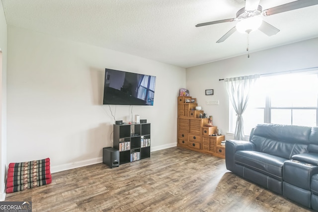 113 Hamlet Ct, Hinesville, GA 31313 - living room with wood finished floors, ceiling fan, and a textured ceiling
