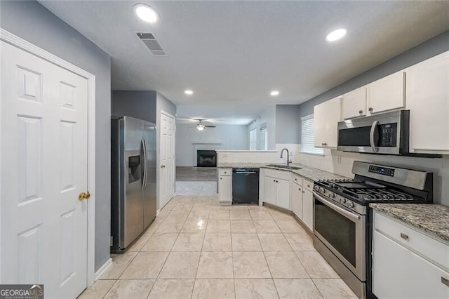kitchen with a ceiling fan, visible vents, a sink, stainless steel appliances, and white cabinetry