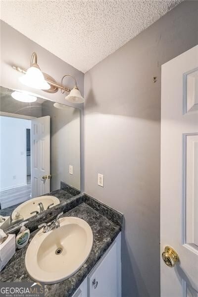 1528 Rogers Crossing Dr, Lithonia, GA 30058 - bathroom with a textured ceiling and vanity