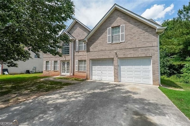 view of front of property with brick siding, driveway, a front lawn, and a garage