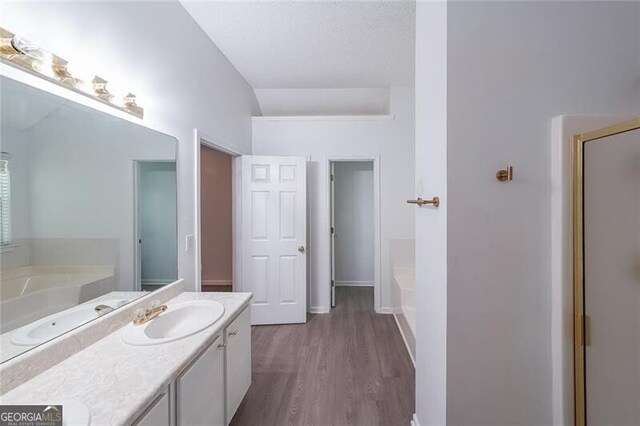 1528 Rogers Crossing Dr, Lithonia, GA 30058 - full bath with a bath, double vanity, wood finished floors, and a stall shower