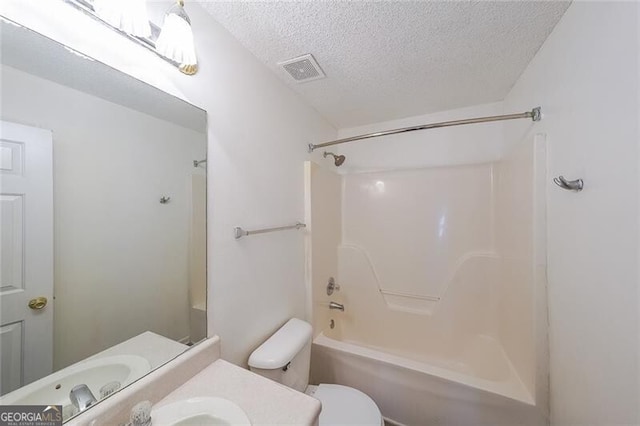 bathroom with vanity, toilet, a textured ceiling,  shower combination, and visible vents