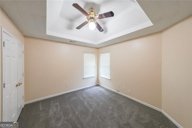 1528 Rogers Crossing Dr, Lithonia, GA 30058 - carpeted empty room with a tray ceiling and ceiling fan