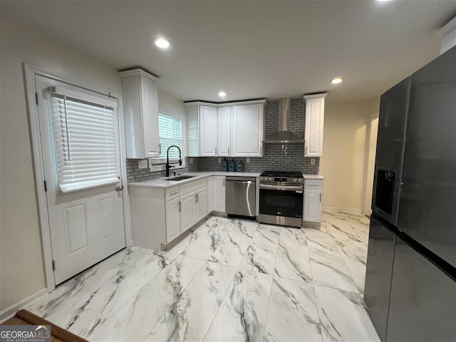 2833 Oldknow Dr NW, Atlanta, GA 30318 - kitchen with wall chimney range hood, appliances with stainless steel finishes, a sink, and light countertops